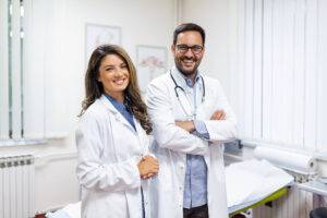 portrait smiling young doctors standing together portrait medical staff inside modern hospital smiling camera